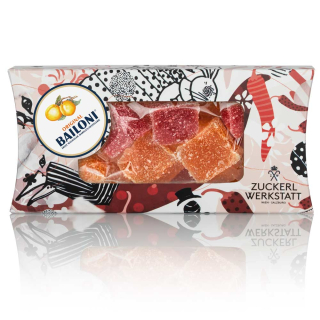 Vegane Fruchtgummis in Rot und Orange in illustrierter Kartonverpackung 

